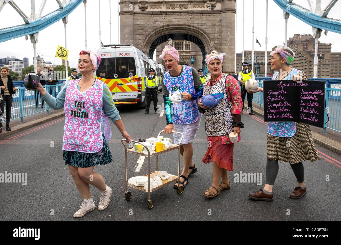 London, UK. 30th Aug, 2021. London, UK 30 8 21 Demonstrators dressed as tea ladies on Tower Bridge. Members of Extinction Rebellion march from The Shard to Tower Bridge where supporters climb on top of a caravan and block the road. Extinction Rebellion Credit: Mark Thomas/Alamy Live News Stock Photo