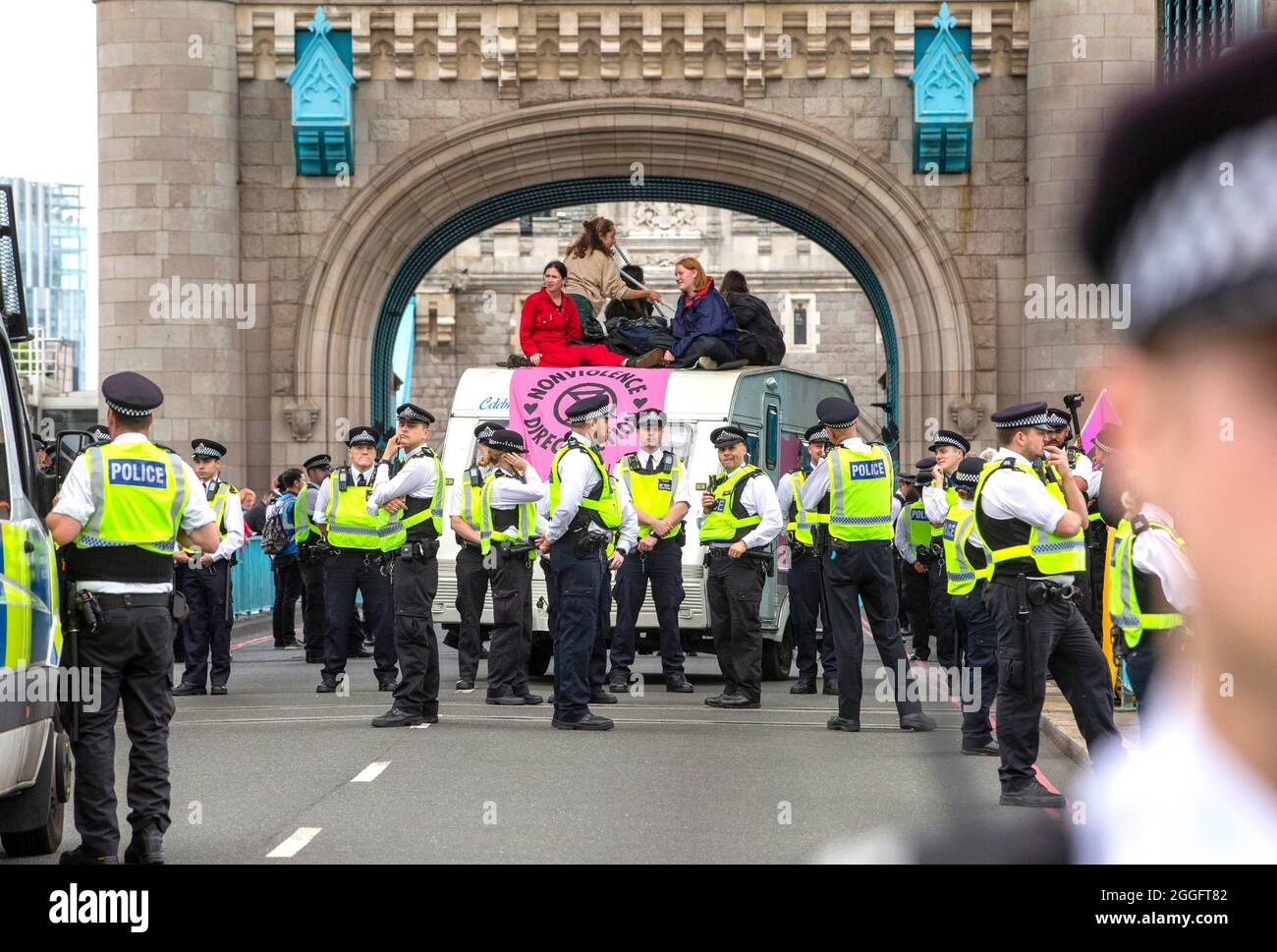 London, UK. 30th Aug, 2021. London, UK 30 8 21 Demonstrators on top of a caravan blocking the road at Tower Bridge. Members of Extinction Rebellion march from The Shard to Tower Bridge where supporters climb on top of a caravan and block the road. Extinction Rebellion Credit: Mark Thomas/Alamy Live News Stock Photo