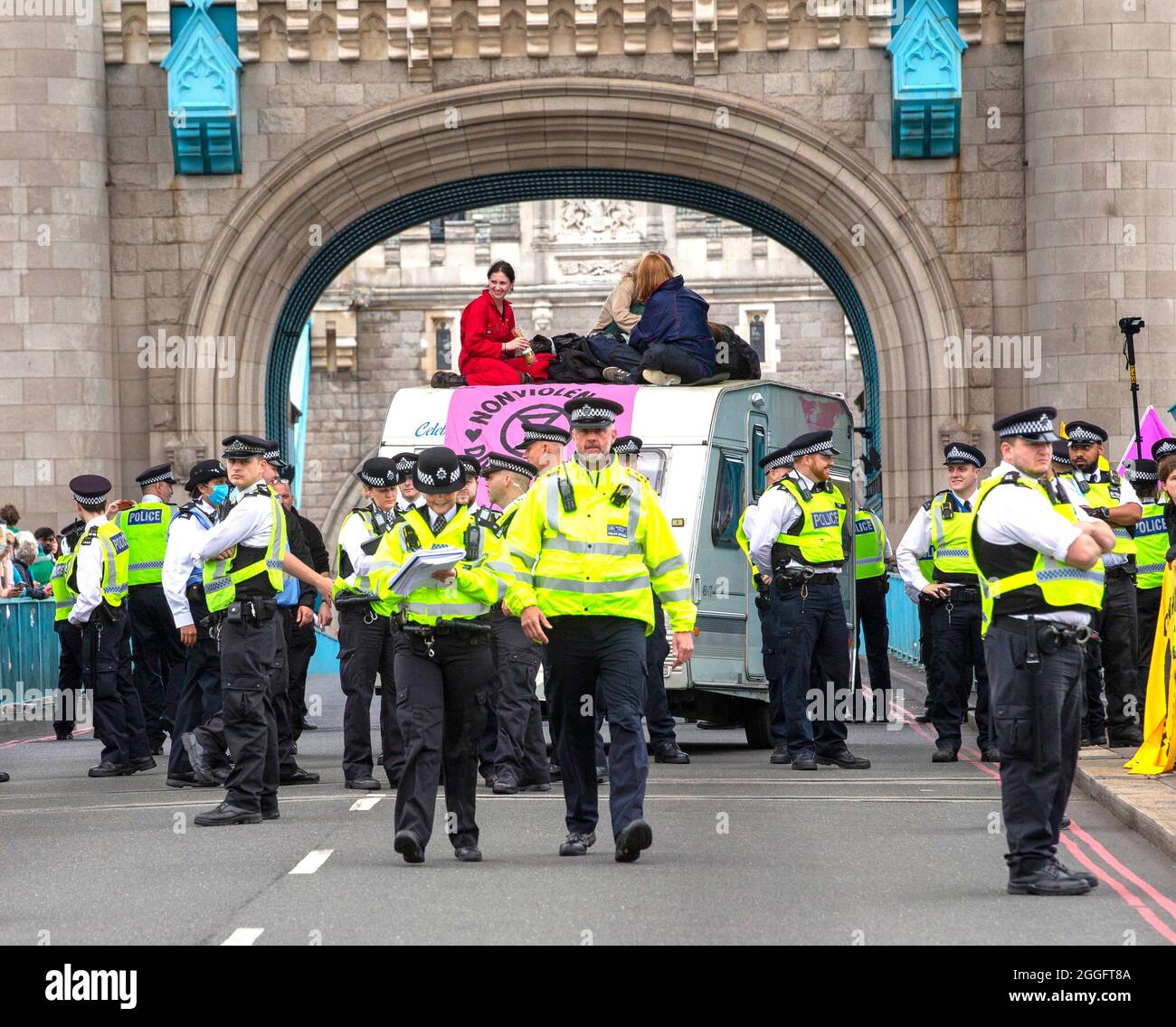 London, UK. 30th Aug, 2021. London, UK 30 8 21 Demonstrators on top of a caravan blocking the road at Tower Bridge. Members of Extinction Rebellion march from The Shard to Tower Bridge where supporters climb on top of a caravan and block the road. Extinction Rebellion Credit: Mark Thomas/Alamy Live News Stock Photo