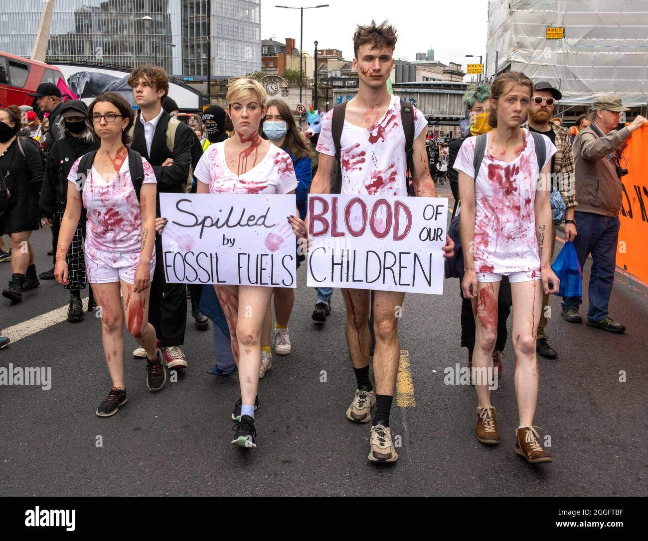 London, UK. 30th Aug, 2021. London, UK 30 8 21 Children on the march smeared in blood. Members of Extinction Rebellion march from The Shard to Tower Bridge where supporters climb on top of a caravan and block the road. Extinction Rebellion Credit: Mark Thomas/Alamy Live News Stock Photo