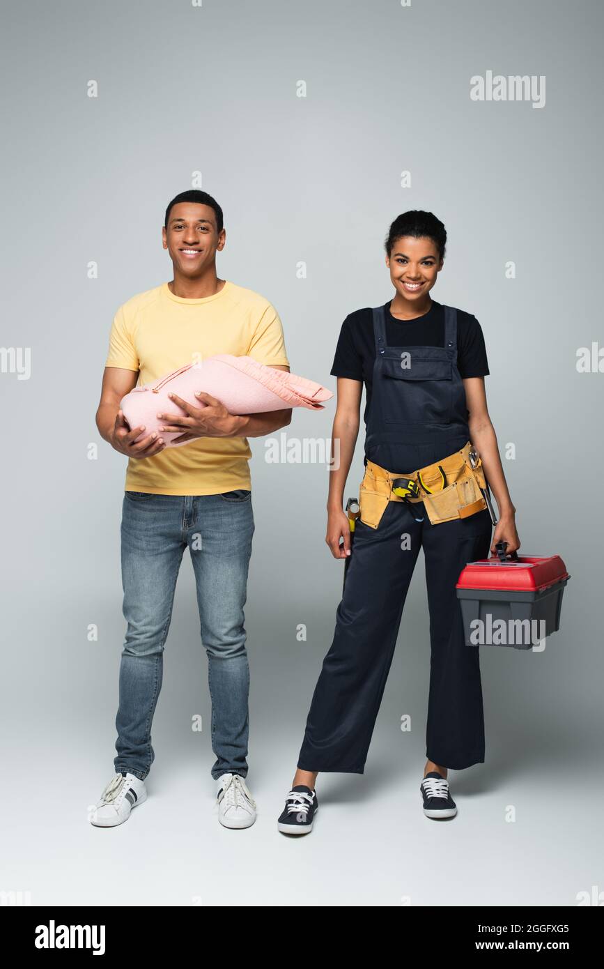 african american father holding baby covered in blanket near