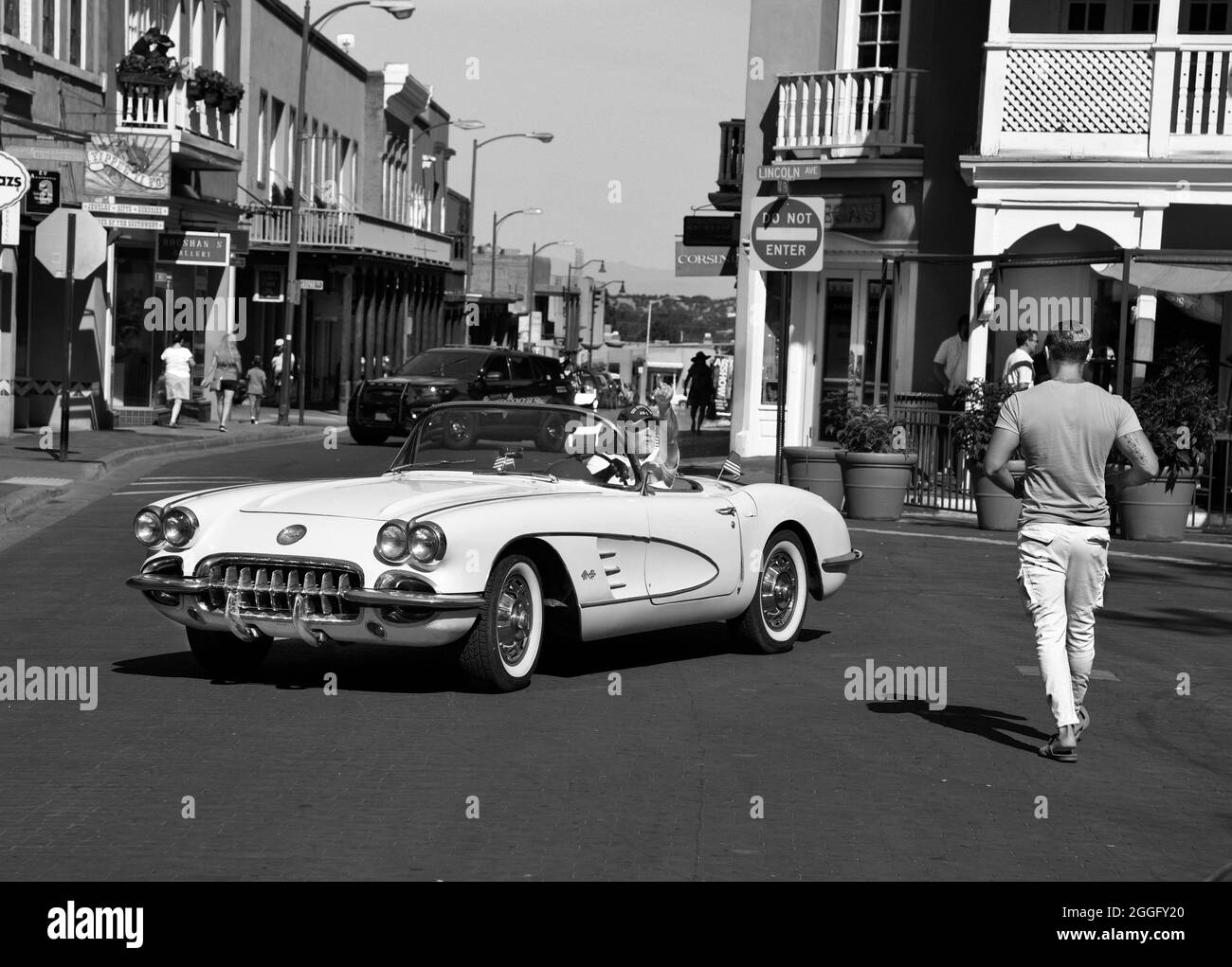 A man drives his vintage 1959 Chevrolet Corvette convertible along a street in downtown Santa Fe, New Mexico. Stock Photo