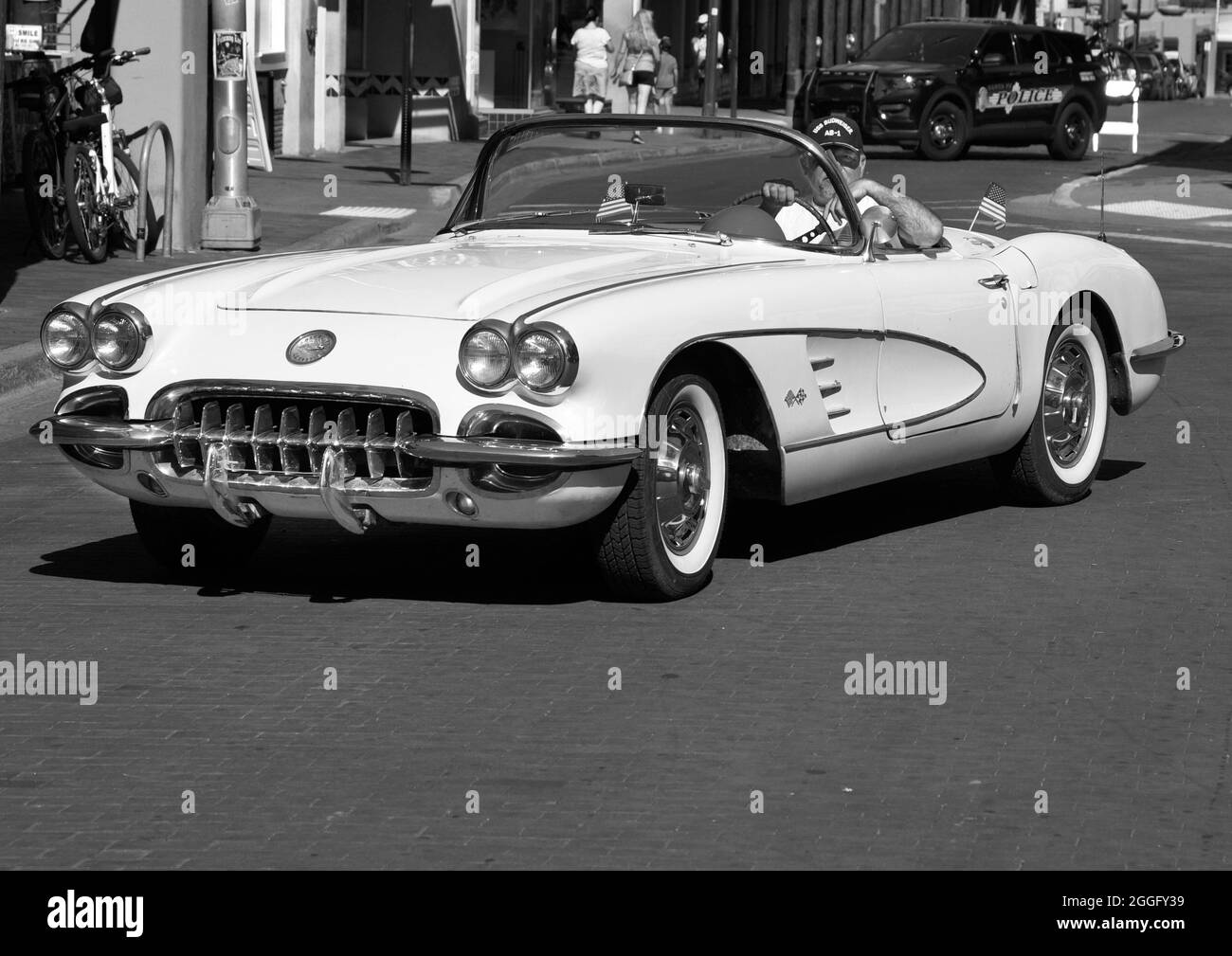 A man drives his vintage 1959 Chevrolet Corvette convertible along a street in downtown Santa Fe, New Mexico. Stock Photo