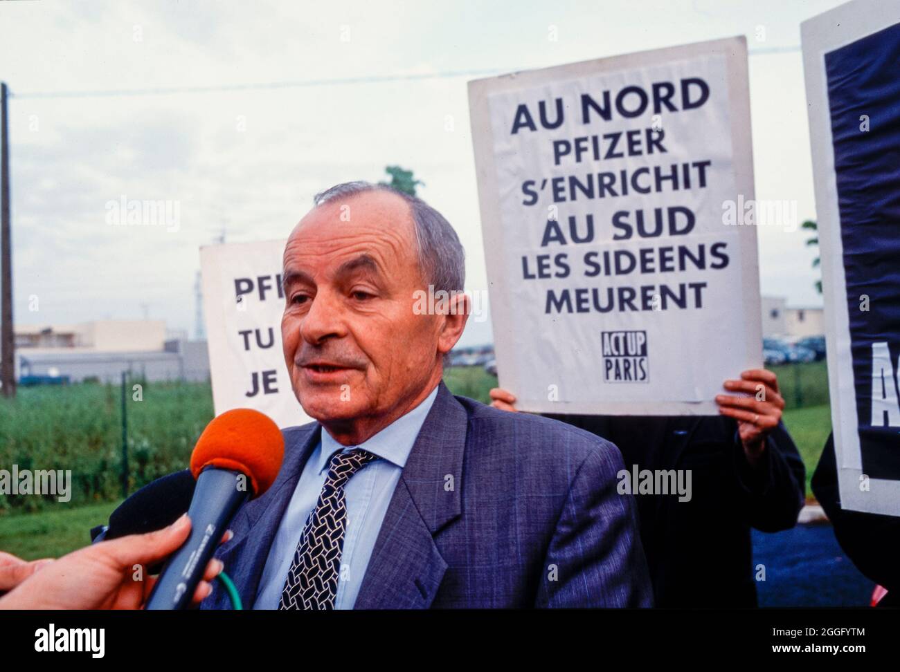 Act Up Paris Demonstration Against Pfizer Pharmaceuticals Company,  AIDS Activists Block Factory Entrance, TV Interview with Factory Manager, pharma industry, Protest against Access to Generic medication decisions Stock Photo