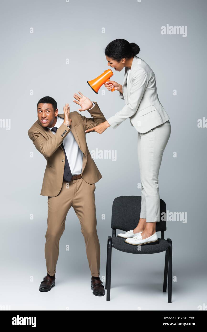 Scared woman standing on chair during a rat invasion Stock Photo - Alamy