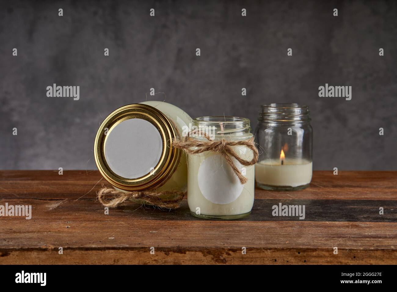 Beauty spa treatment and relaxation concept. candle for relaxing spa massage and body treatment on a wooden table and gray background. horizontal and Stock Photo