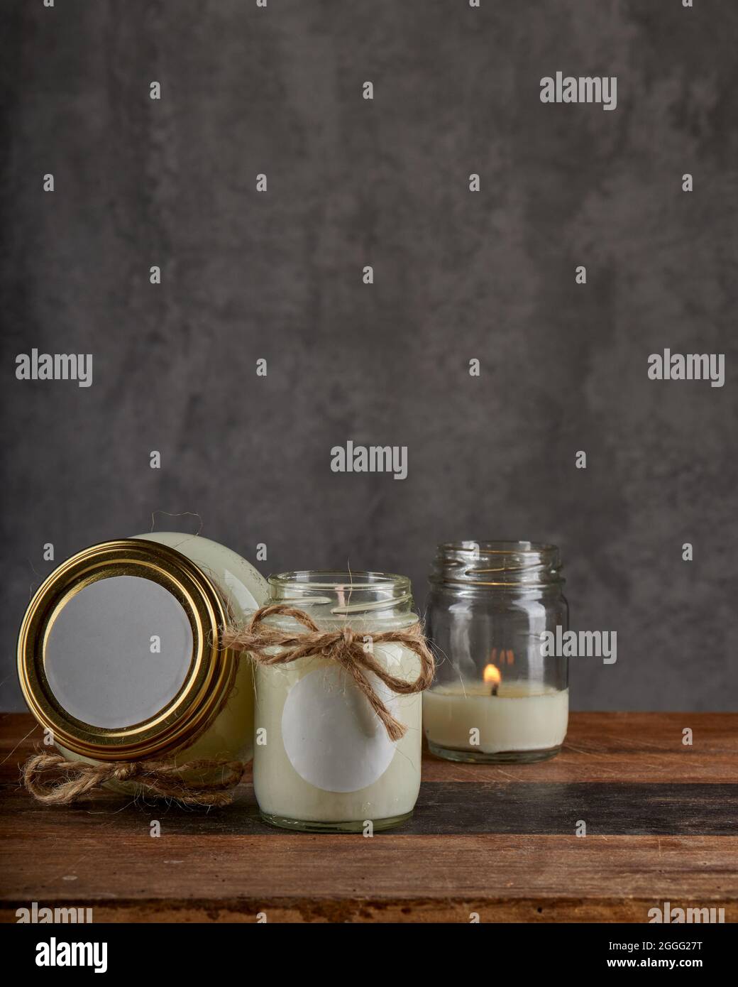 Products spa treatment and relaxation concept. candle for relaxing spa massage for body and face on a wooden table and gray background. Vertical and c Stock Photo