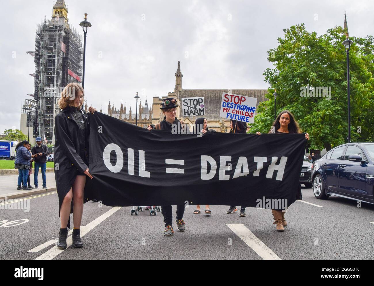 London, UK. 31st Aug, 2021. Protesters dressed in black hold an 'Oil=Death' banner during the Pram Rebellion.Extinction Rebellion protesters dressed in black marched with prams in Westminster as part of their two-week Impossible Rebellion campaign, calling on the UK Government to act meaningfully on the climate and ecological crisis. Credit: SOPA Images Limited/Alamy Live News Stock Photo