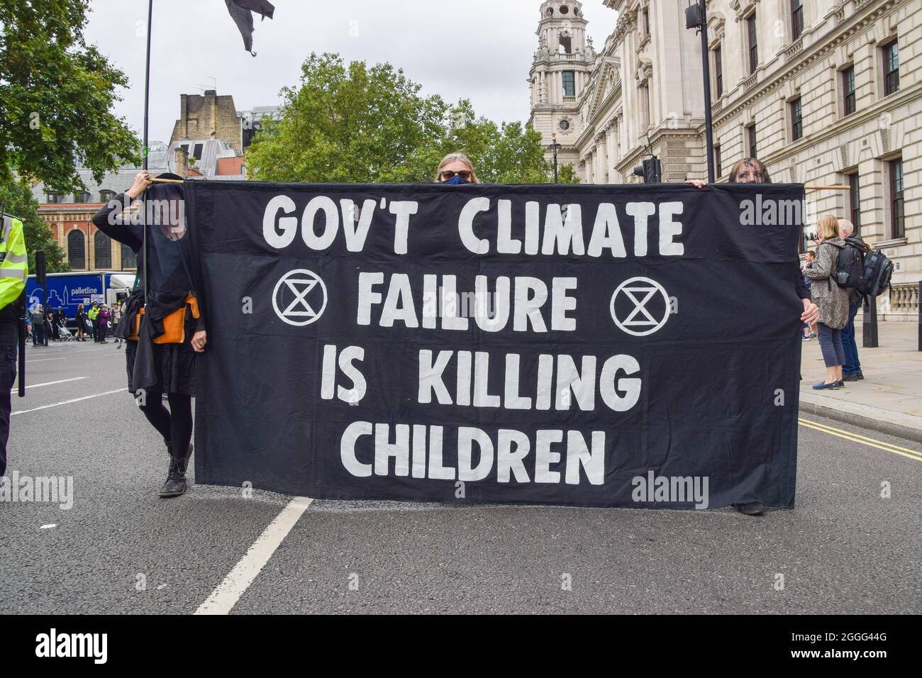 London, UK. 31st Aug, 2021. Protesters dressed in black hold a banner critical of the government's climate policies during the Pram Rebellion.Extinction Rebellion protesters dressed in black marched with prams in Westminster as part of their two-week Impossible Rebellion campaign, calling on the UK Government to act meaningfully on the climate and ecological crisis. (Photo by Vuk Valcic/SOPA Images/Sipa USA) Credit: Sipa USA/Alamy Live News Stock Photo