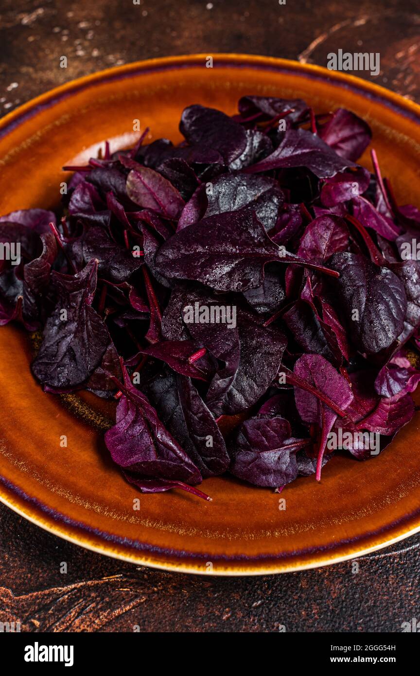 Raw Ruby or red chard salad Leafs on a rustic plate. Dark background. Top view Stock Photo