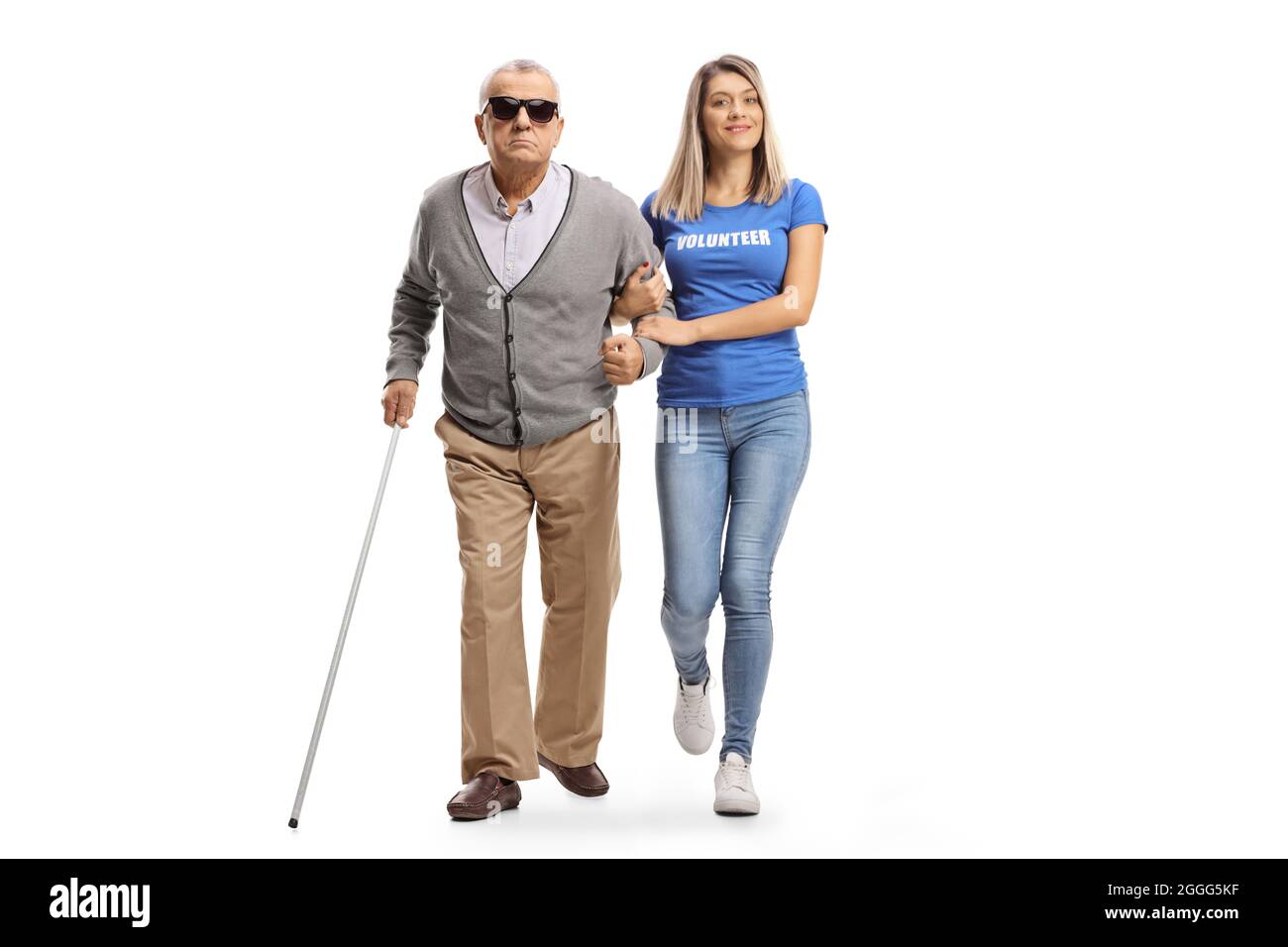 Full length portrait of a young female volunteer helping an elderly blind man walking with a cane isolated on white background Stock Photo