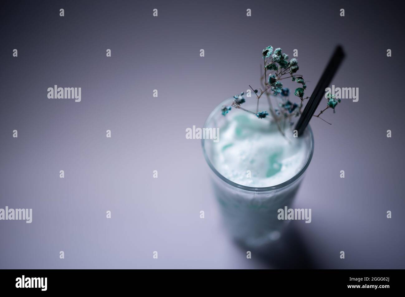 milk drink or cocktail blue hawaii decorated in glass on grey background Stock Photo