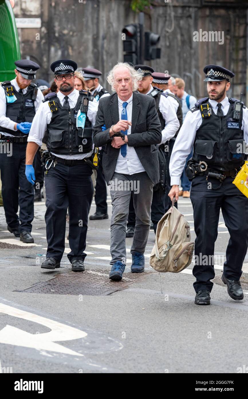 London, UK. 31st Aug, 2021. Police arrest a protester who was removed from an open top bus used to block the junction on the south side of London Bridge on the 9th day of the Impossible Rebellion.The protest group by Extinction Rebellion are undertaking two weeks of civil disobedience, demonstrations and protests. Credit: SOPA Images Limited/Alamy Live News Stock Photo