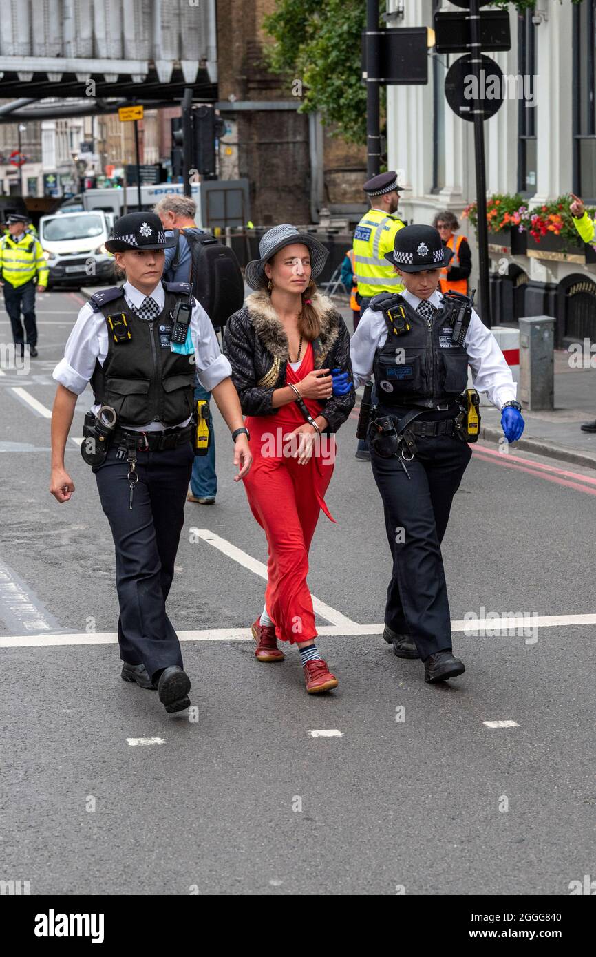 London, UK. 31st Aug, 2021. Police arrest a protester who was removed from an open top bus used to block the junction on the south side of London Bridge on the 9th day of the Impossible Rebellion.The protest group by Extinction Rebellion are undertaking two weeks of civil disobedience, demonstrations and protests. (Photo by Dave Rushen/SOPA Images/Sipa USA) Credit: Sipa USA/Alamy Live News Stock Photo