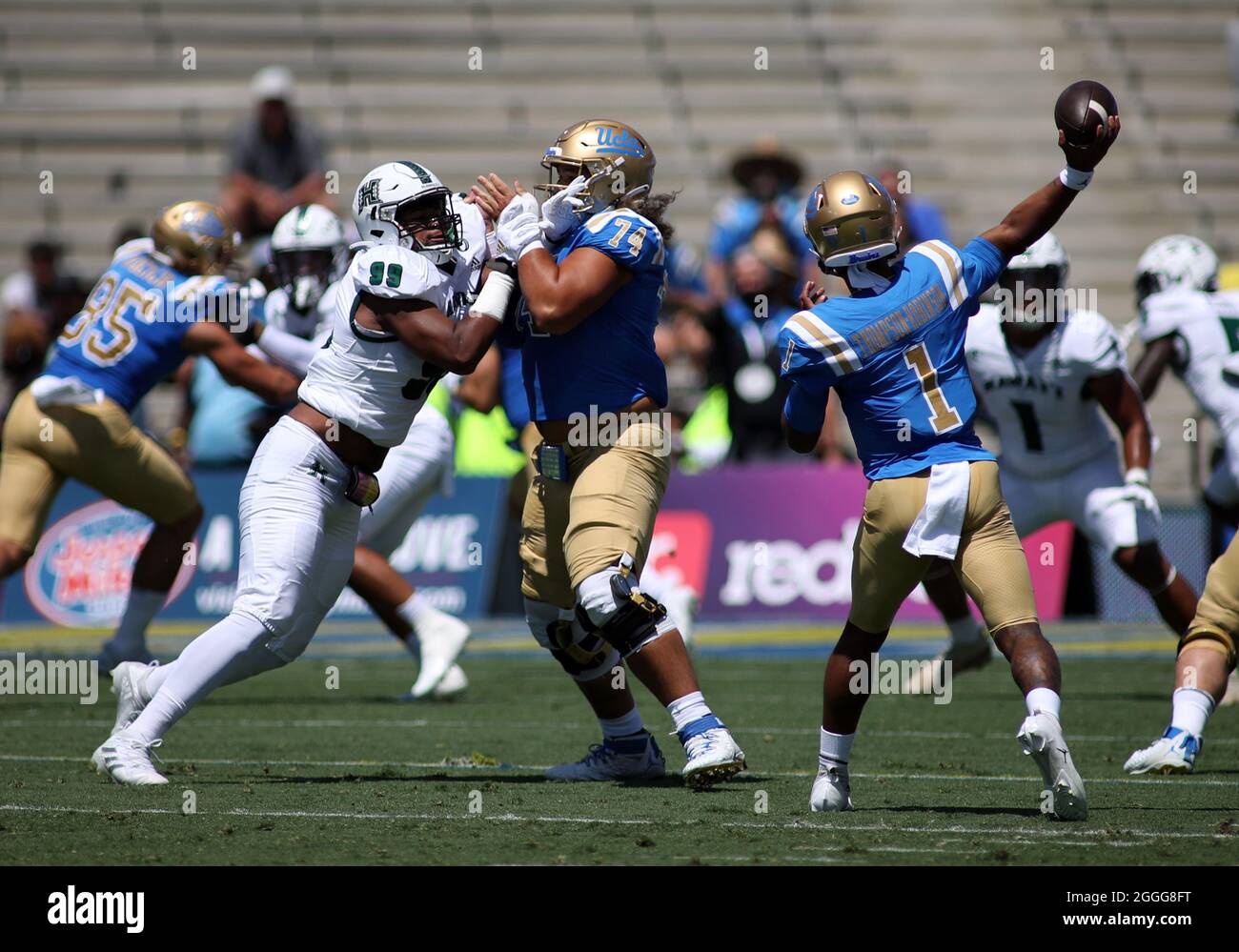 August 28, 2021 - UCLA Bruins offensive lineman Sean Rhyan #74 holds off Hawaii Rainbow Warriors defensive lineman Jonah Laulu #99 while UCLA Bruins quarterback Dorian Thompson-Robinson #1 throws a pass during a game between the UCLA Bruins and the Hawaii Rainbow Warriors at the Rose Bowl in Pasadena, CA - Michael Sullivan/CSM Stock Photo