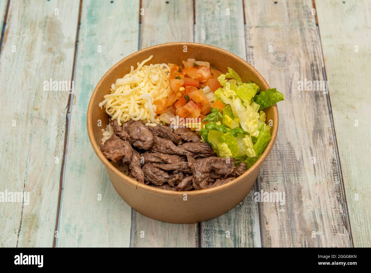 Grated cheese in plastic container on table Stock Photo - Alamy