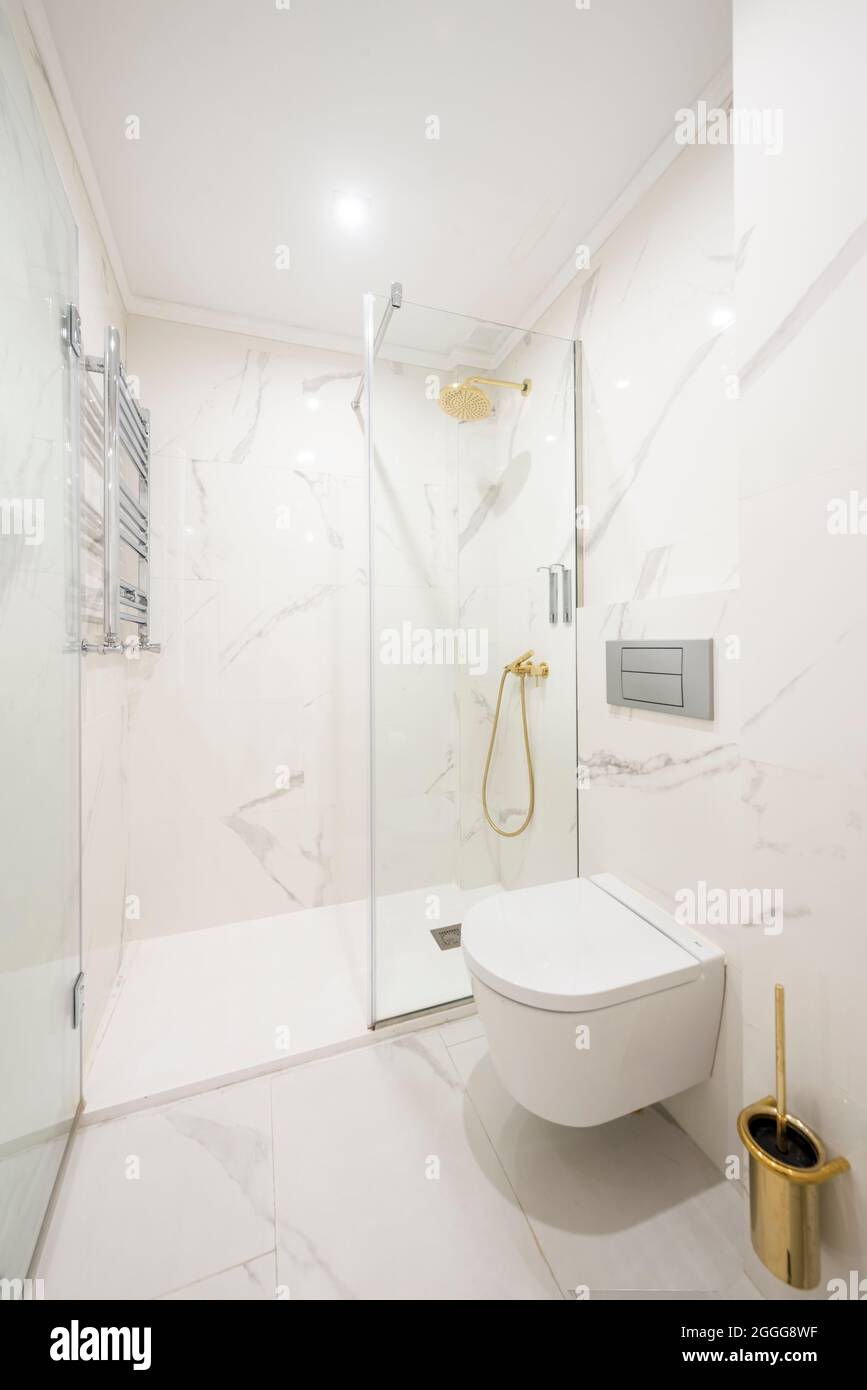 Shower with screen in white marble bathroom with towel dryer radiator Stock  Photo - Alamy