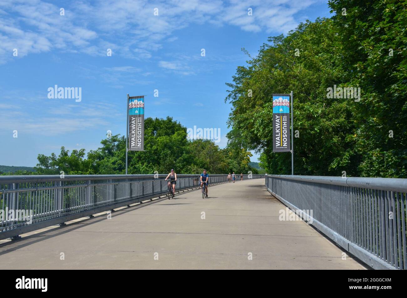 Walkway Over the Hudson State Historic Park, the world's longest pedestrian park. Biking on the bridge in Poughkeepsie, New York, USA.  July 17, 2021. Stock Photo