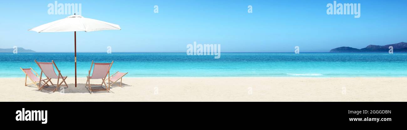 Wooden deck chairs on sandy beach near sea. Holiday background Stock ...