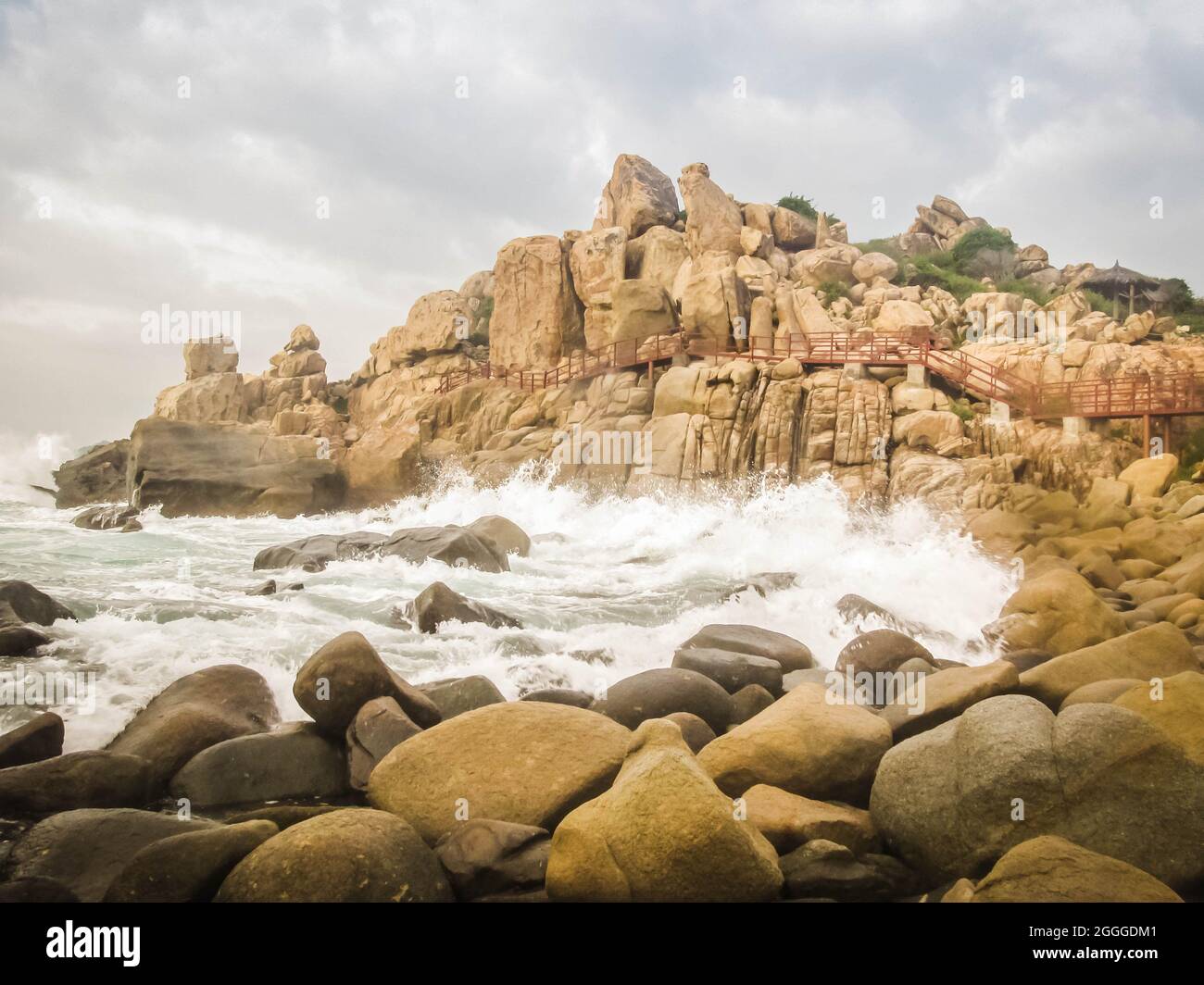 Exposure photo of a rocky beach on a cloudy day near Rai cave, in Ninh Thuan, Vietnam Stock Photo