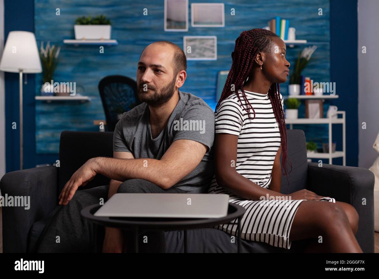 Irritated interracial couple with marriage problems fighting at home. Mixed race people feeling angry and having argument about relationship. Multi ethnic partners with dispute. Stock Photo