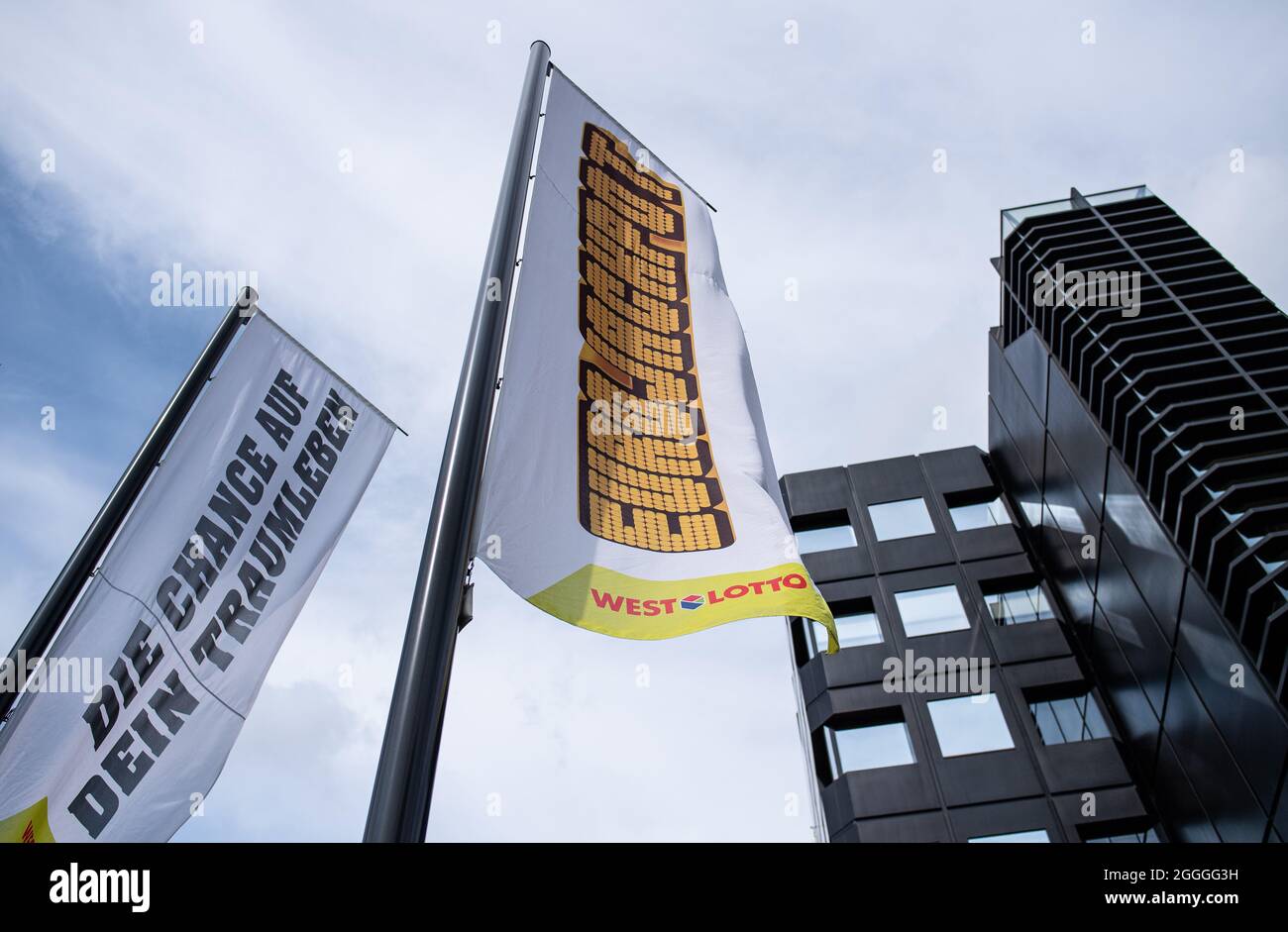 PRODUCTION - 09 August 2021, North Rhine-Westphalia, Münster: A flag with  the words "Eurojackpot" flies in front of the headquarters of Westlotto,  the lottery company of the state of North Rhine-Westphalia. Changes