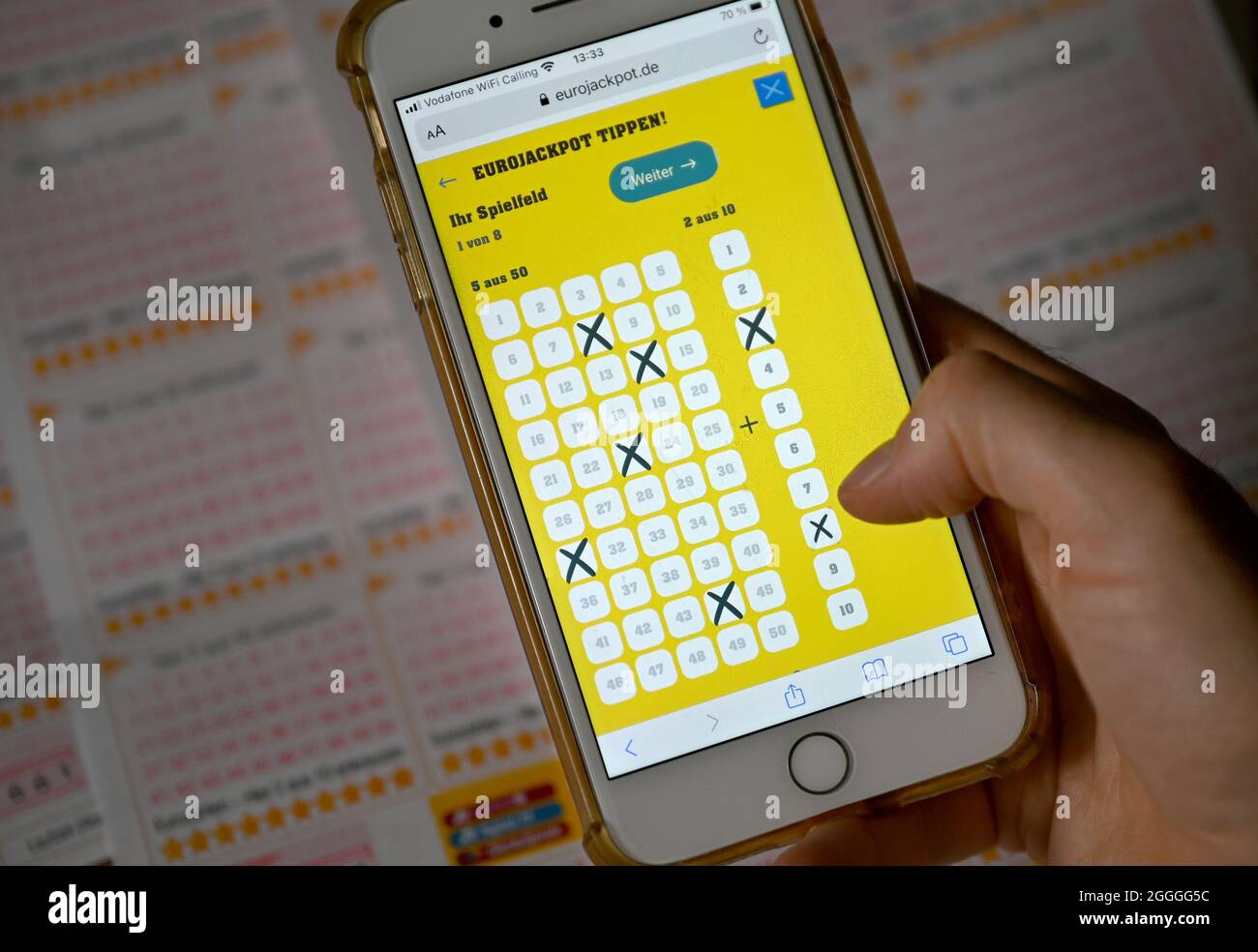 Berlin, Germany. 30th Aug, 2021. A man fills out a Eurojackpot lottery  ticket on a smartphone. There are changes to the Eurojackpot. The upper  limit climbs to 120 million euros, in addition,
