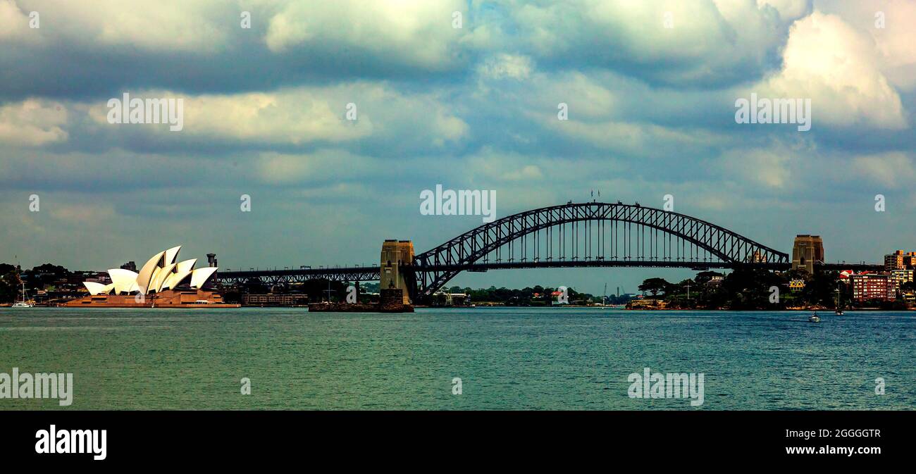 Sydney Opera House and Harbour Bridge panorama taken from Manly Ferry with blue sky and white clouds Stock Photo