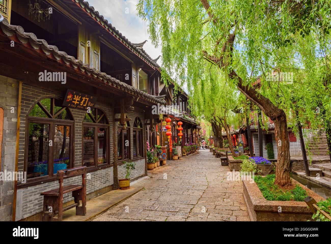 Yunnan, China - 22 March 2016: Quaint streets and historical wooden shophouses in Lijiang ancient town. Stock Photo