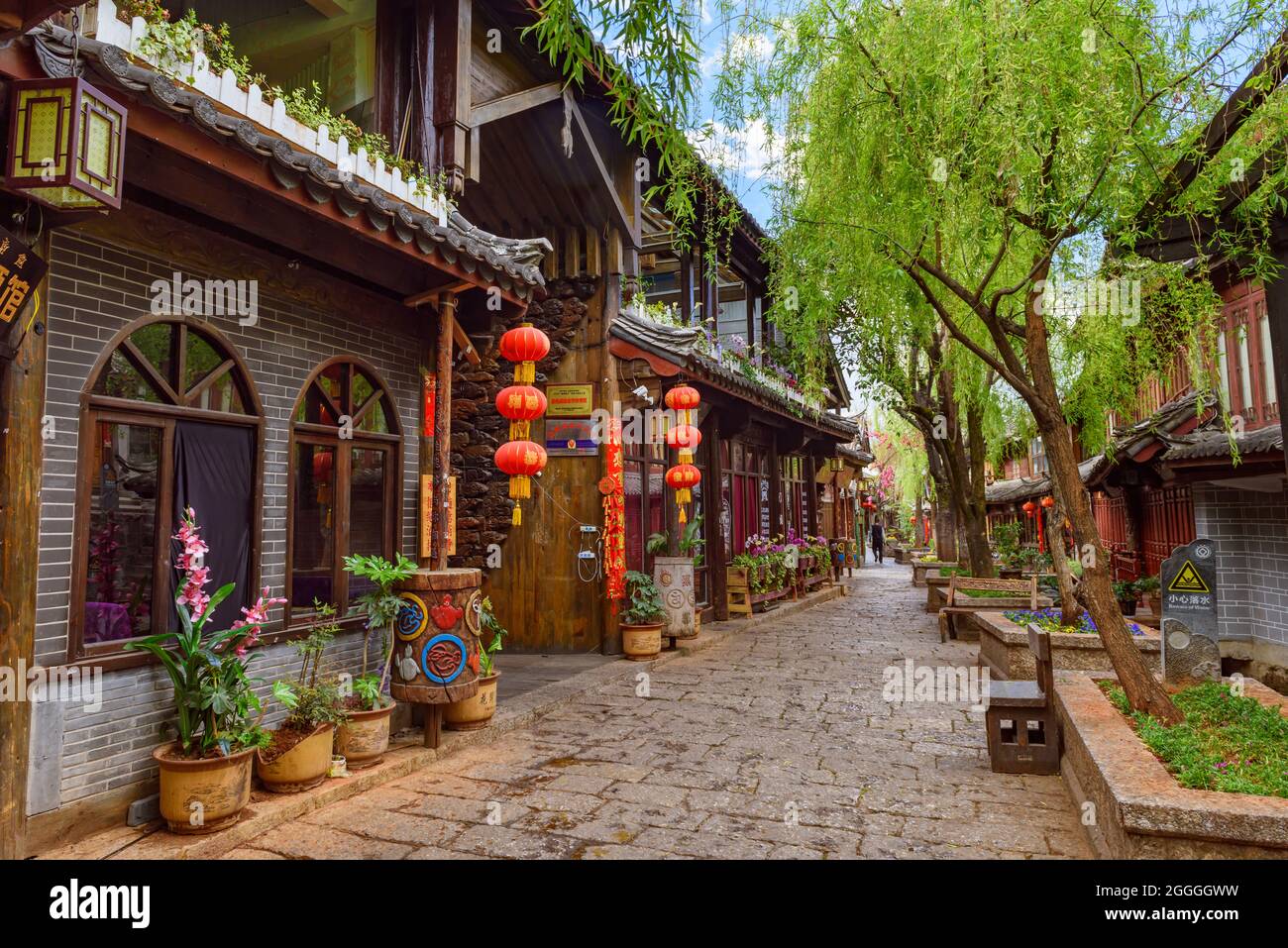 Yunnan, China - 22 March 2016: Quaint streets and historical wooden shophouses in Lijiang ancient town. Stock Photo
