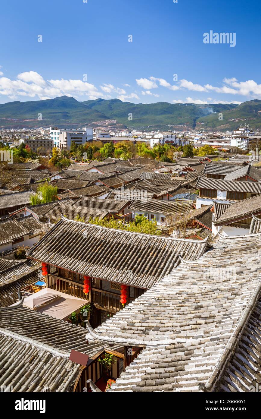 Beautiful cityscape of Lijiang ancient town with view of tiled roofs of ancient shophouses, Yunan, China. Stock Photo
