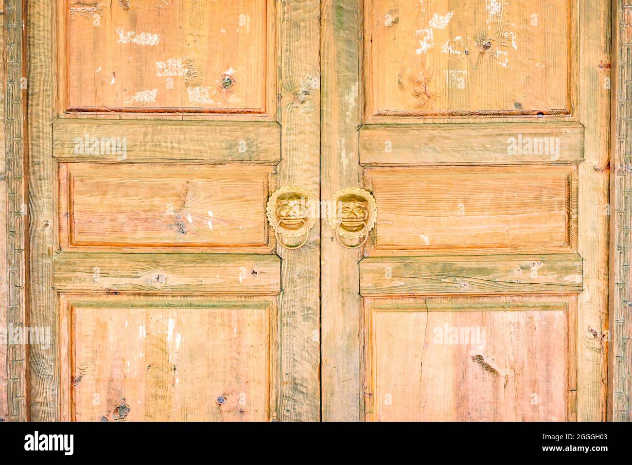 Old traditional worn down wooden doors for textures and backgrounds. Stock Photo