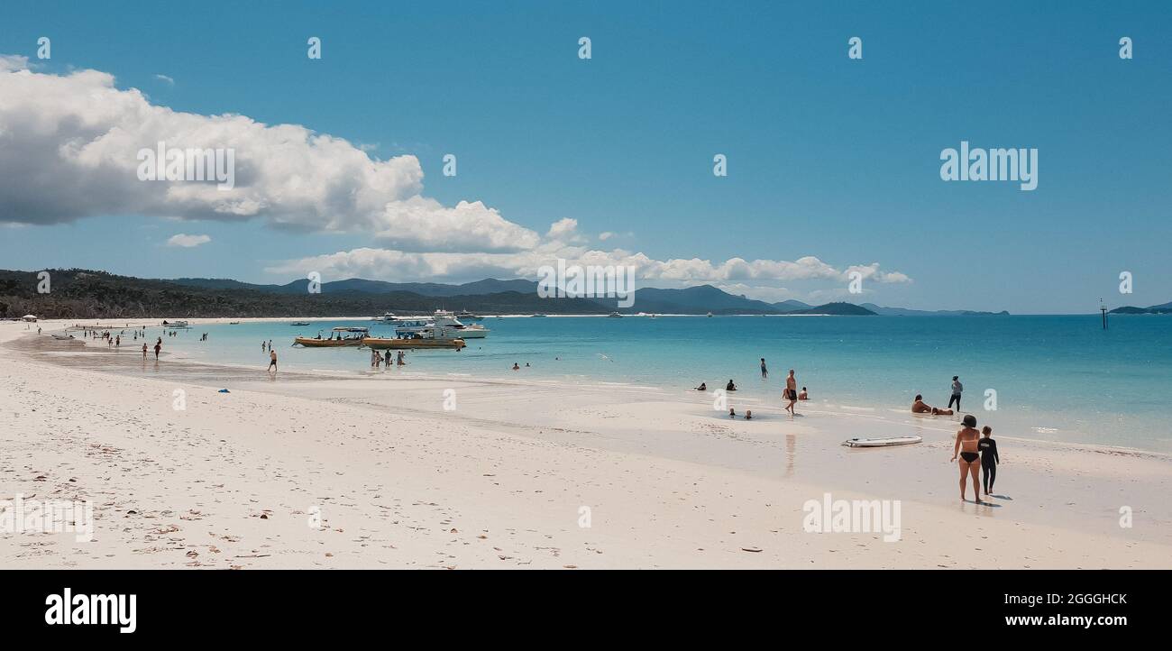 Whitehaven Beach, Queensland Australia - 7 October 2018 - Beach scene with swimmers and boats in the Whitsundays Stock Photo