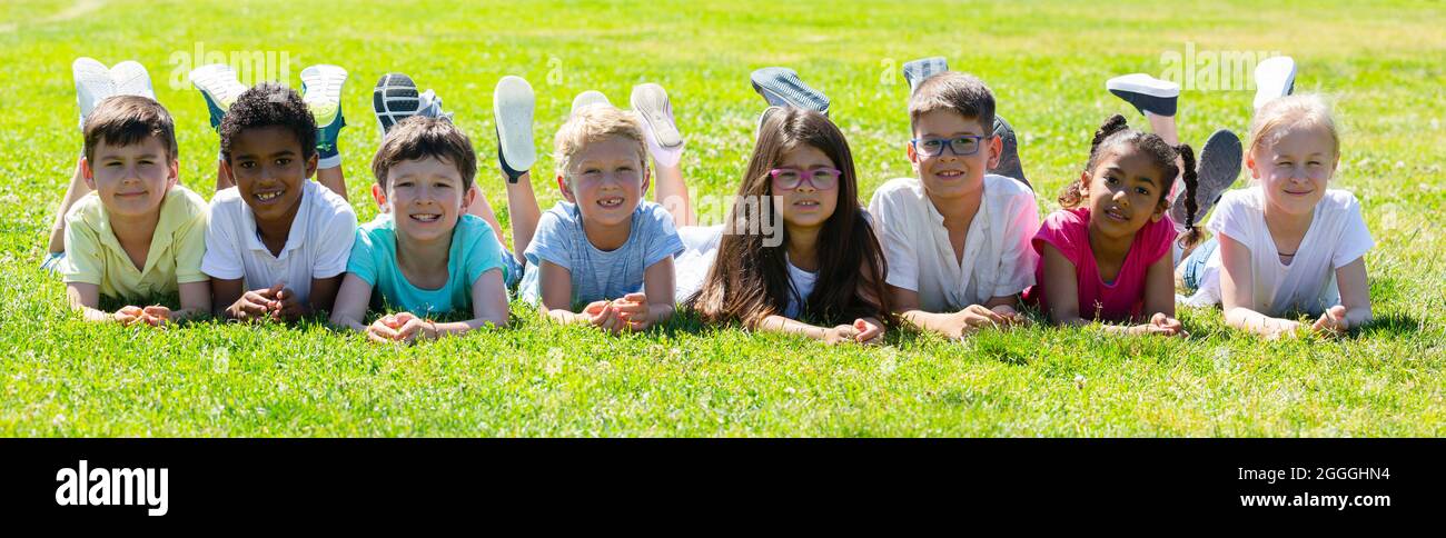 Portrait of children who are posing lying in the park Stock Photo - Alamy
