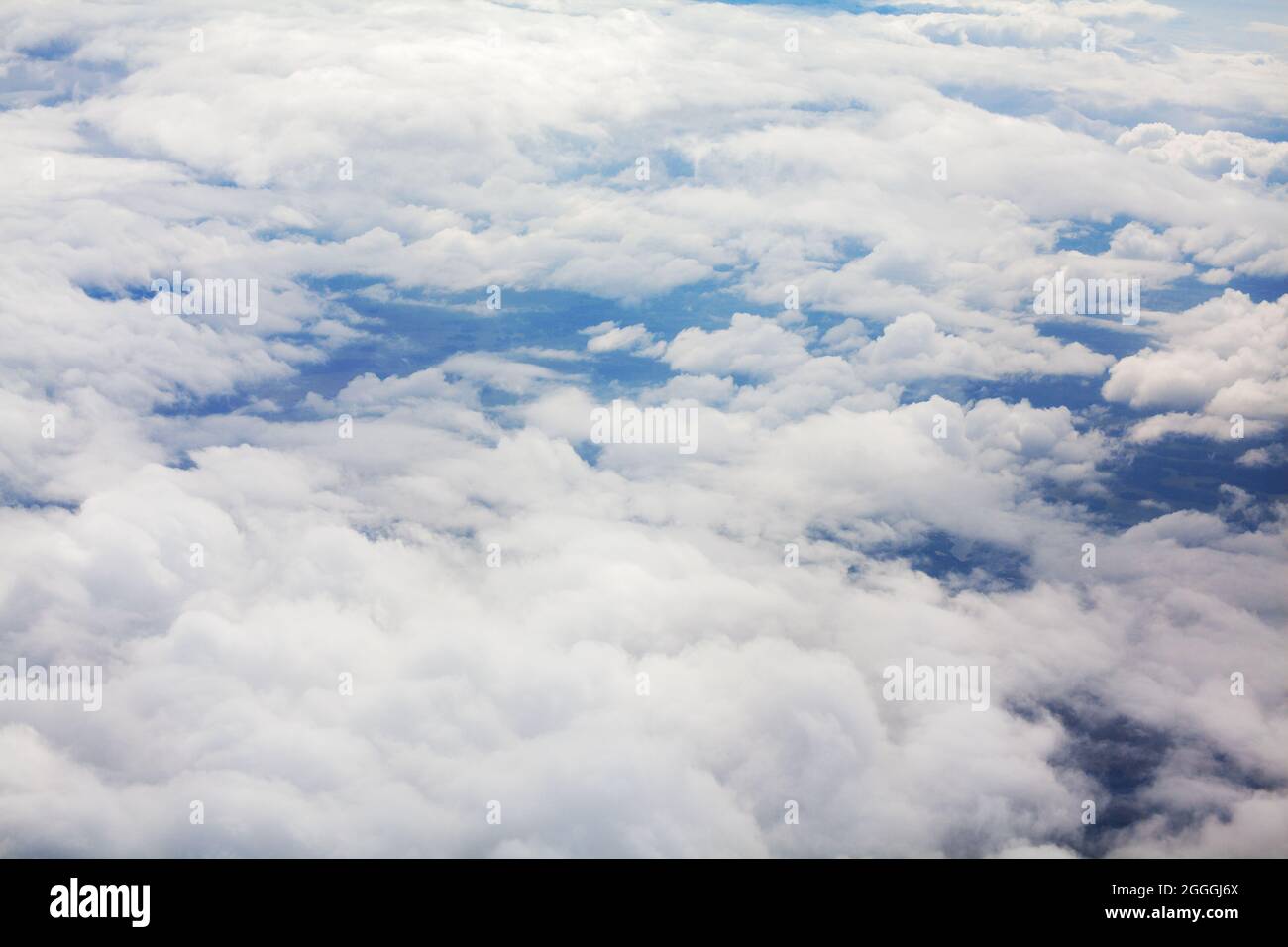 White clouds blue sky background view from above, airplane flight landscape, beautiful aerial cloudscape, skies backdrop, fluffy cloud texture, heaven Stock Photo