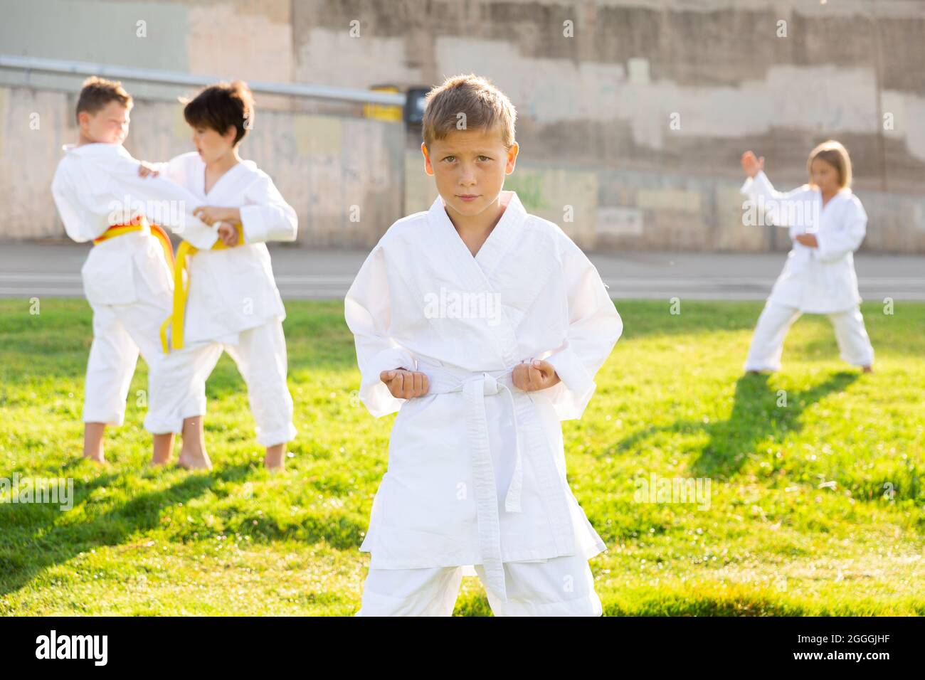 Boy throws a punch at martial arts practice Stock Photo Alamy