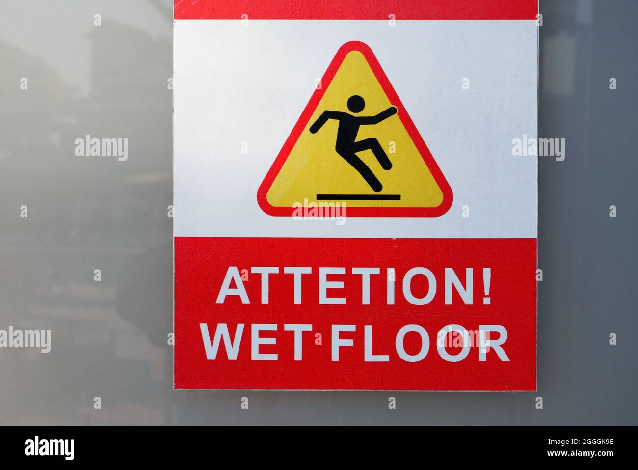 red wet floor warning sticker on the wall Stock Photo