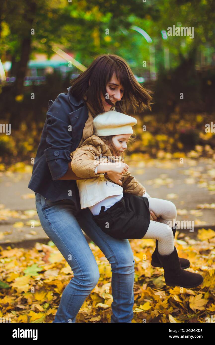 Young mother and her daughter have fun at autumn Stock Photo - Alamy