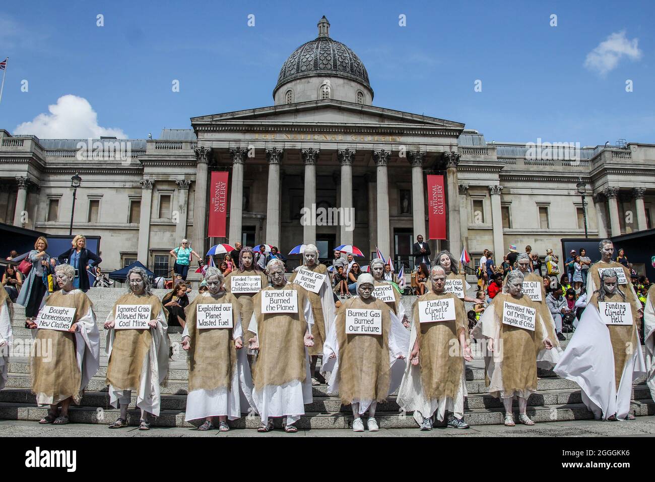 London, United Kingdom. 24th August 2021. Extinction Rebellion Penitents march through London, from Piccadilly to Parliament Square. Unlike other XR groups whose actions are mainly performative, the Penitents bring a profoundly contemplative mood to the rebellion. Their march is an inner meditation. The penitents carry the burden of all human crimes against the environment and humans and a placard describing their own sin. Stock Photo