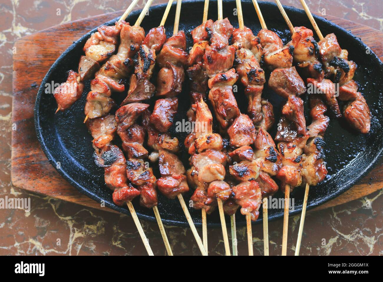 Goat satay or sate kambing in the hot plate Stock Photo