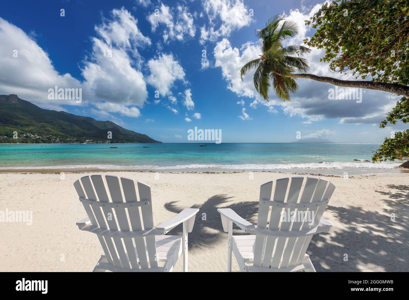 Sandy beach with beach chairs in tropical island Stock Photo