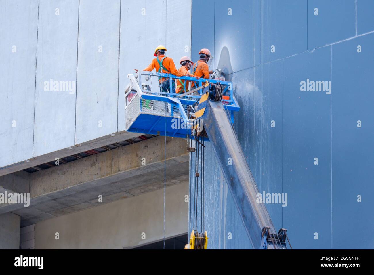 Crane with construction workers with real work Stock Photo - Alamy