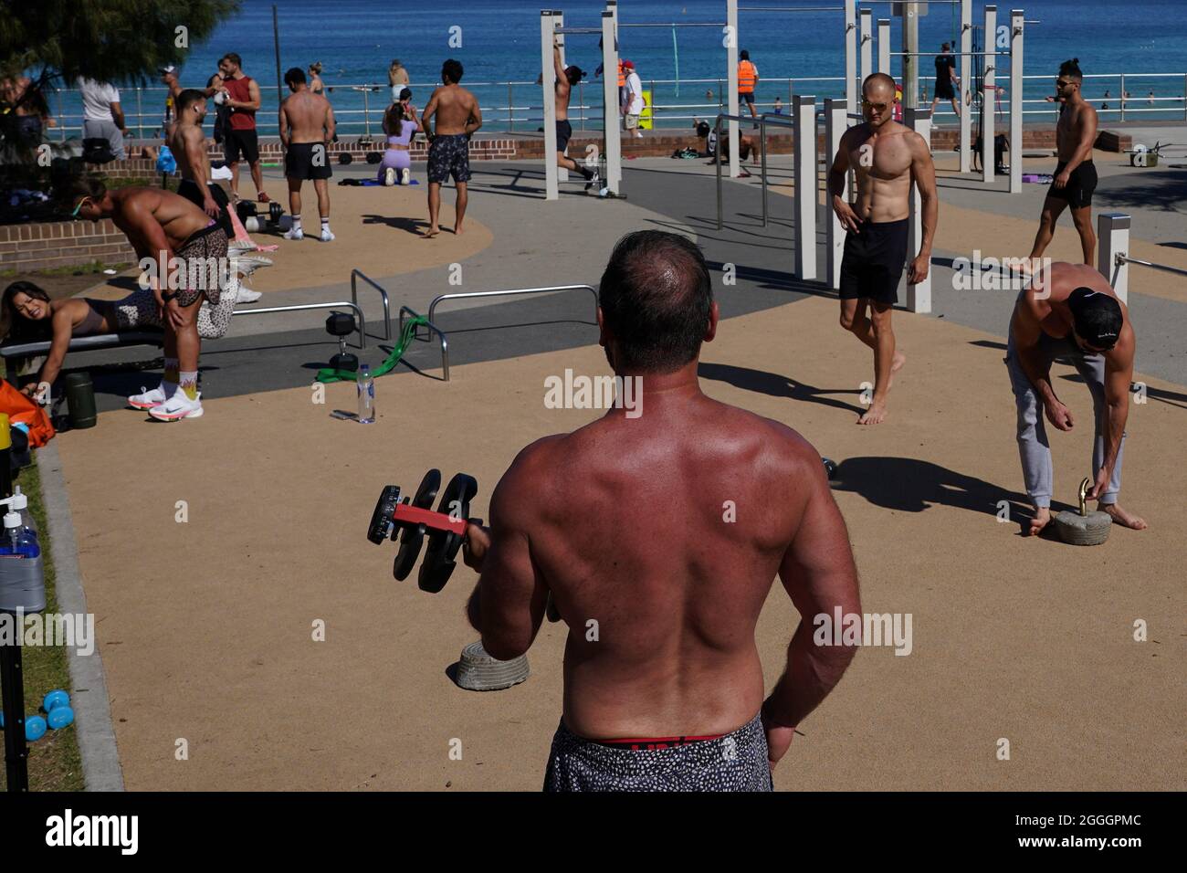 People exercise in the outdoor gym area at Bondi Beach during a lockdown to  curb the