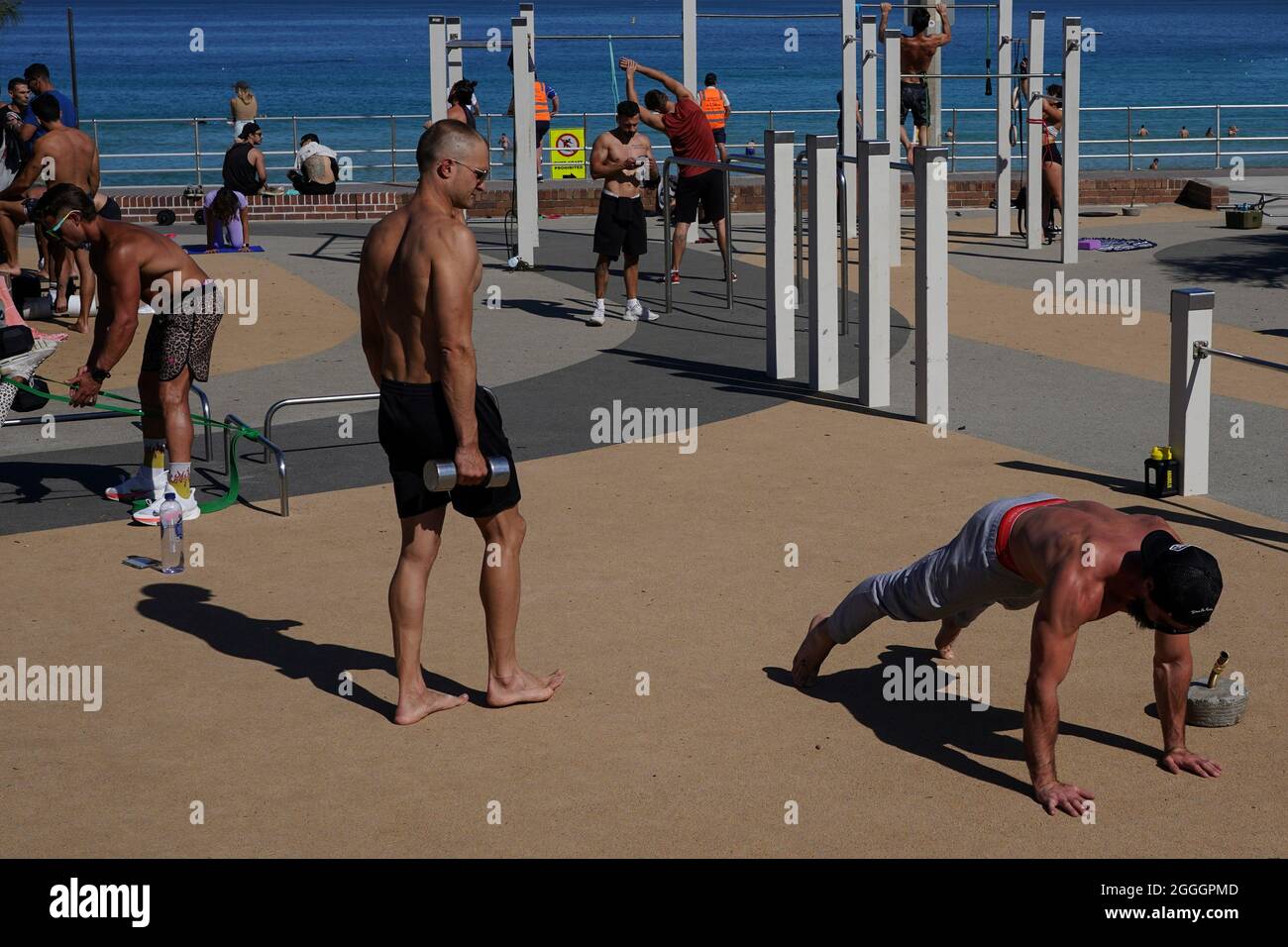 People exercise in the outdoor gym area at Bondi Beach during a lockdown to  curb the