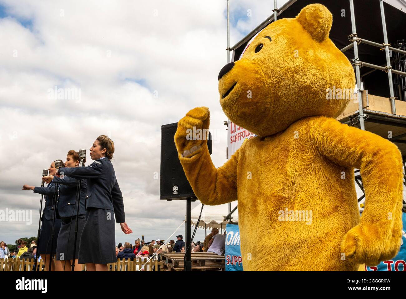 Pudsey Bear mimicking the D-Day Darlings singers at the Little Gransden airshow for the BBC Children in Need charity. Outside event Stock Photo