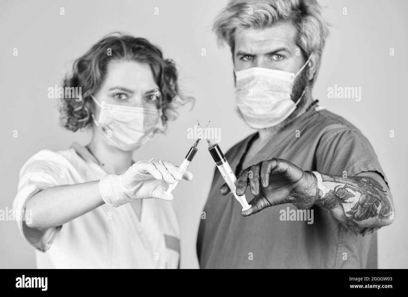 medical couple. virus remedy injection. doctors wear respirator mask. infection vaccine and blood test. Medical professional working. medical couple Stock Photo
