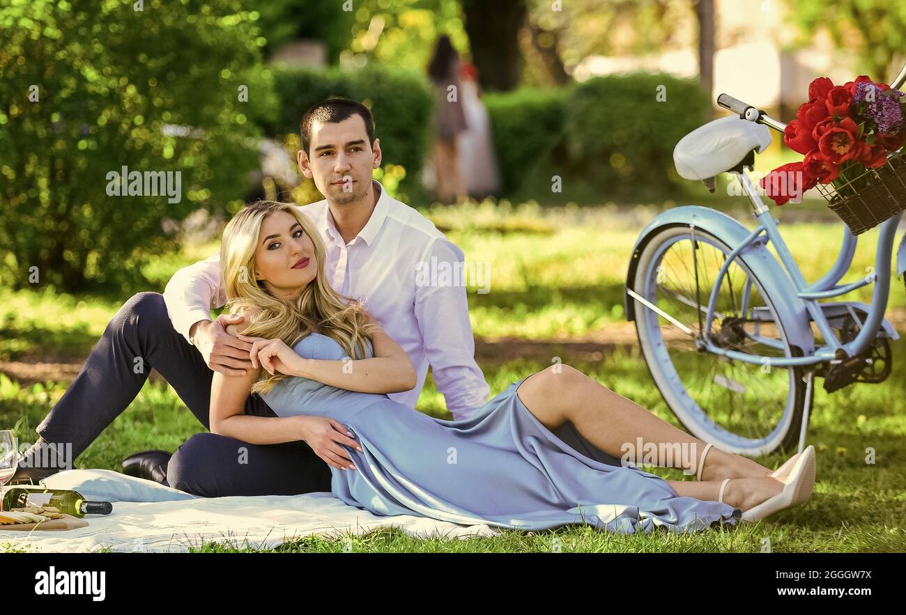 nice summer holiday. girl and man travel by retro bicycle. couple in love  drinking wine during romantic dinner in park. romantic picnic of couple in  Stock Photo - Alamy