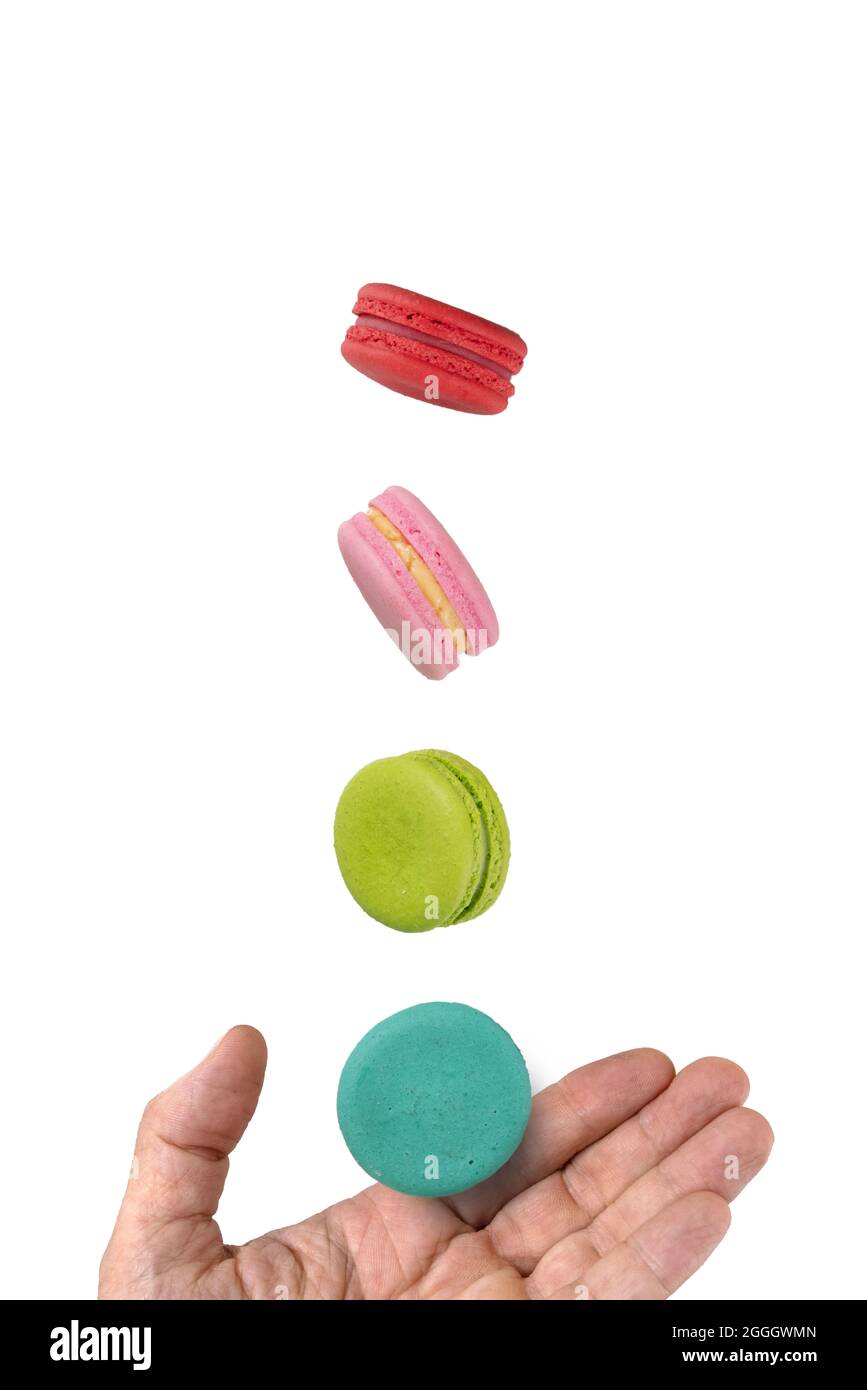 Colorful macaroons levitating on a hand. Levitation food photography concept. Stock Photo