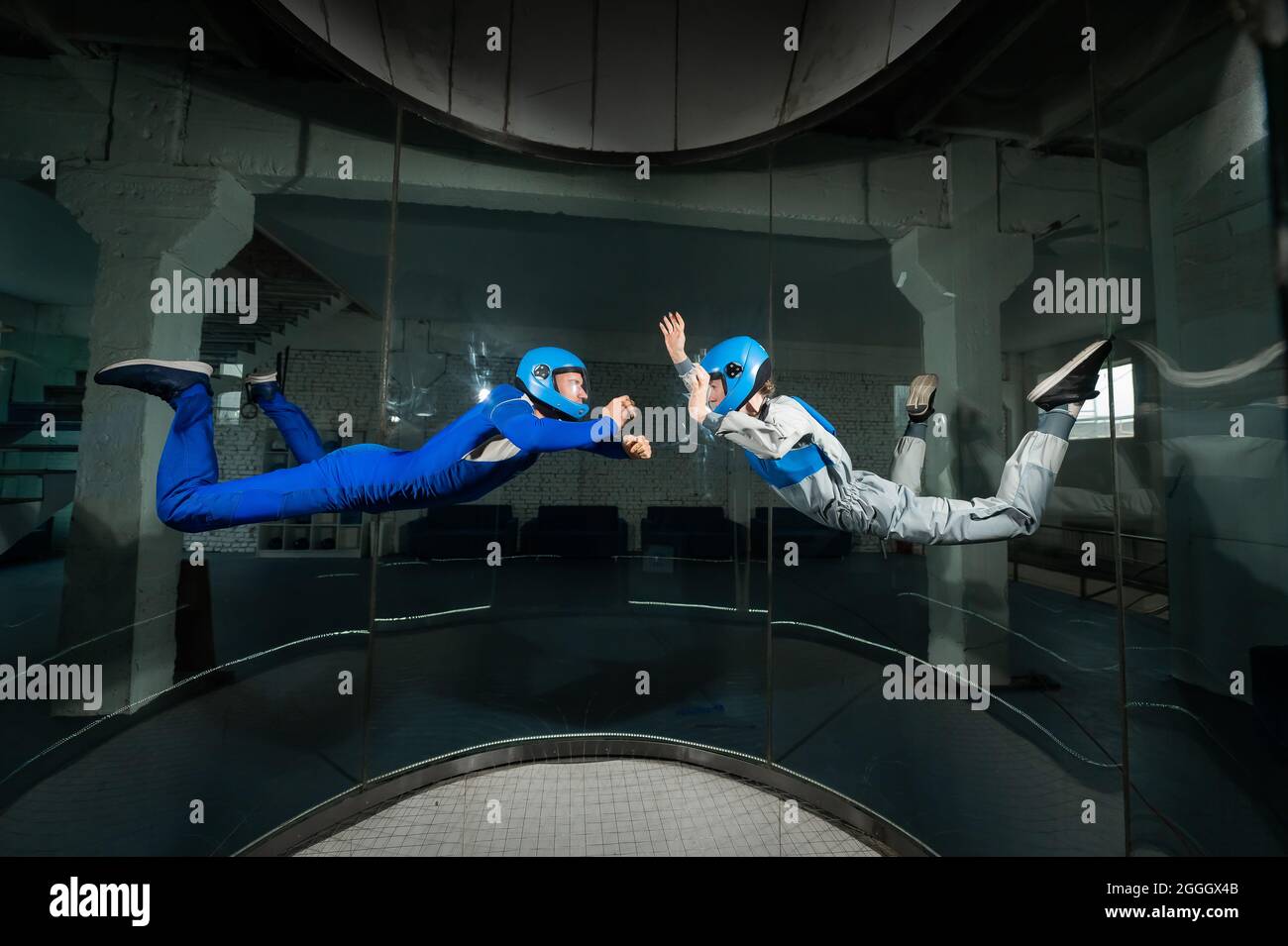 A man and a woman enjoy flying together in a wind tunnel. Free fall ...