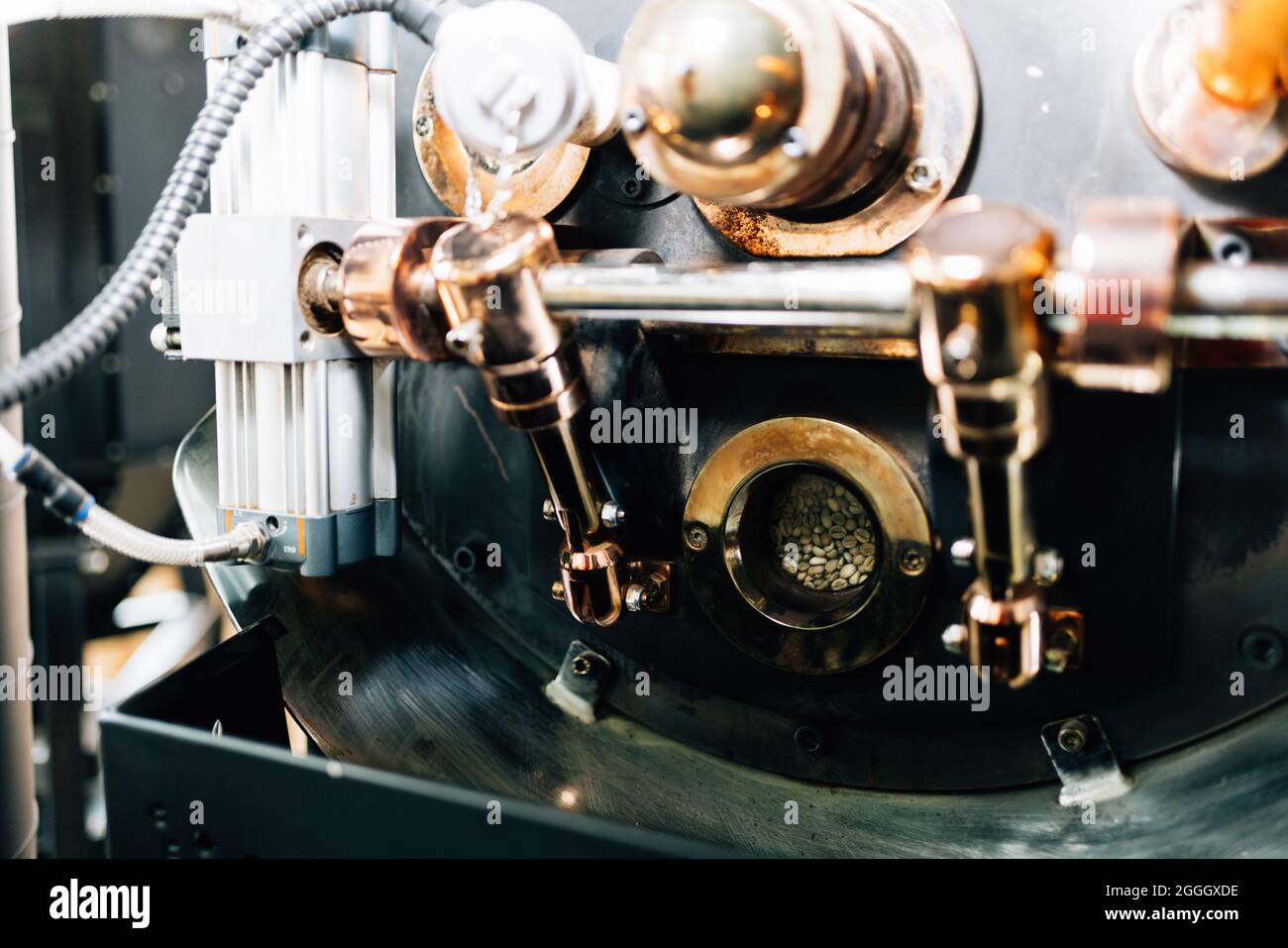 Coffee shop owners show technology how to bake raw coffee beans in a